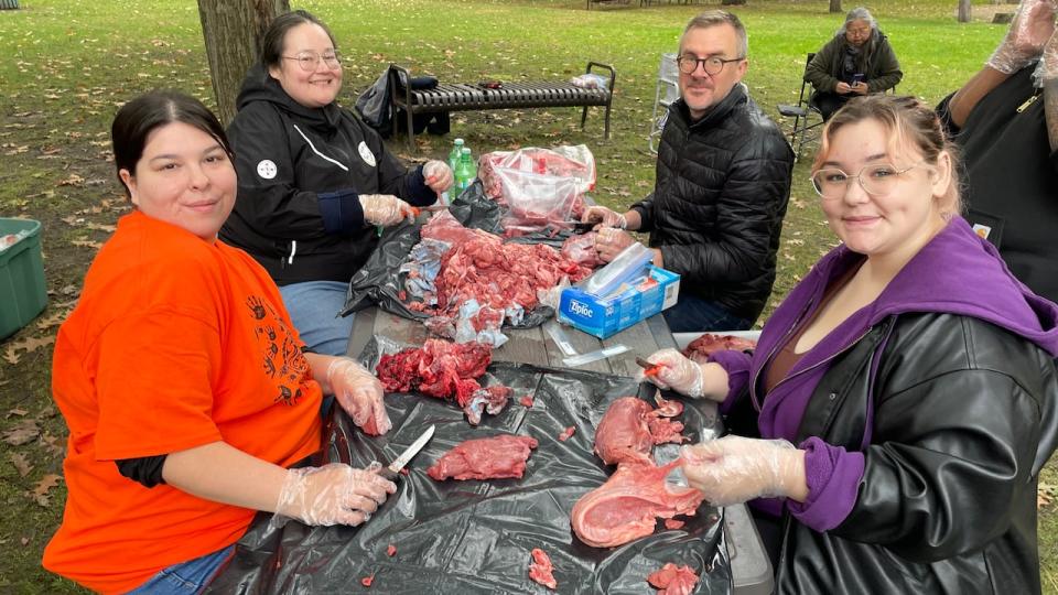 Far right, Julia Clement, Mi'kmaq from Listuguj, Que. says it was her first time learning how to butcher moose meat. 