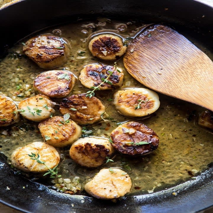 Scallops cooking in butter.