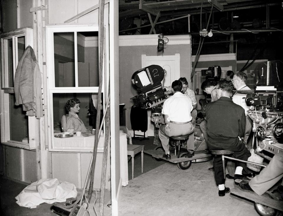 <p>In 1951, Lucille and Desi premiered their hit show <em>I Love Lucy</em>, which featured them as a married couple living in New York City. Here, the actress is seen through the set's window.</p>