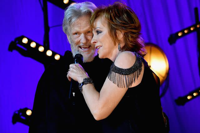 <p>Rick Diamond/Getty</p> Reba McEntire and Kris Kristofferson perform in 2016.