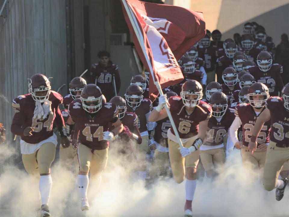 Killingly senior Ben Jax (6) leads the team onto Rentschler Field for the Class MM championship game Saturday.