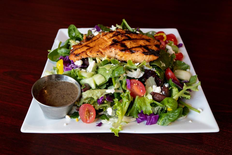 The Greek salad with salmon is one of the menu items at Horizons Bar and Grille in Bannerman Crossing. 