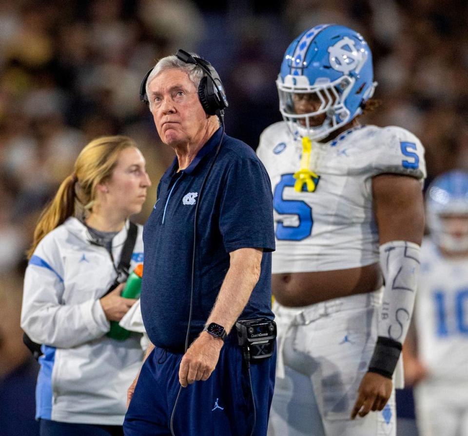 North Carolina coach Mack Brown checks the video replay as he walks to check on Devontez Walker (9) who was injured by Georgia Tech’s Kyle Efford (44) and Ahmari Harvey (18) in the fourth quarter on Saturday, October 28, 2023 at Bobby Dodd Stadium in Atlanta, Georgia.