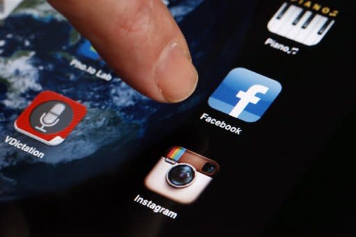 A man shows the smartphone Facebook application on an Iphone in April 2012. Some are offended by the price set for Facebook, a site founded by Zuckerberg just eight years ago from his Harvard dorm room. Still only 27, he will retain 57.3 percent of the voting power of the shares