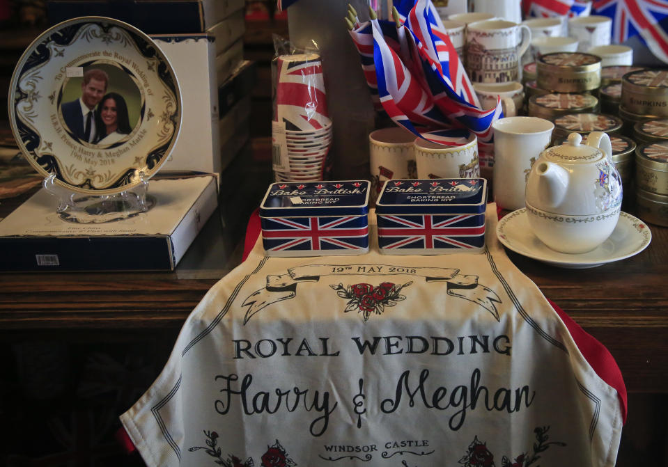 FILE - Memorabilia of Britain's royal couple Prince Harry and Meghan Markle is available for purchase at Tea and Sympathy, May 17, 2018, in New York. The pomp, the glamour, the conflicts, the characters — when it comes to the United Kingdom’s royal family, the Americans can’t seem to get enough. (AP Photo/Bebeto Matthews, File)