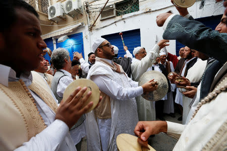 Libyan Sufi Muslims chant and hit drums and cymbals during a procession to commemorate Prophet Mohammad's birthday, also known as Mawlid, in the old city of the Libyan capital Tripoli, Libya November 20, 2018. REUTERS/Ismail Zitouny