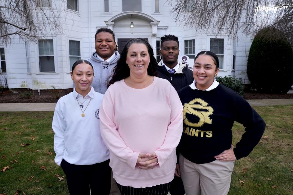 Kaitlin Della Grotta, center, executive director of Rhode Islanders Sponsoring Education, with RISE scholarship students who attend St. Raphael Academy in Pawtucket. From left: God’iss Santos, Khamari Brown, Aaron Julius and Dazayah Cosme.