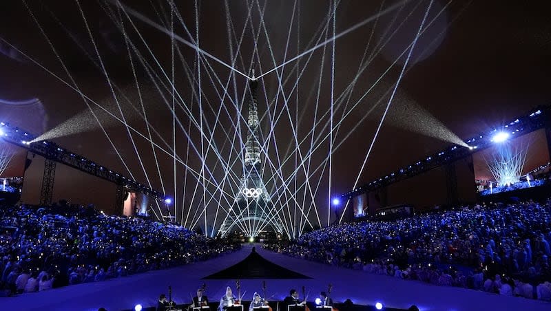 A light show is projected from the Eiffel Tower in Paris, France, during the opening ceremony of the 2024 Summer Olympics, Friday, July 26, 2024.