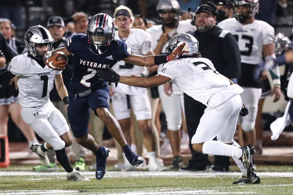 Veterans Memorial's Christian Sabsook evades tackle by PSJA North's Stephen Garza during the playoff game at Buccaneer Stadium. The Eagles defeated the Raiders, 20-14, on Saturday, Dec. 3, 2022.