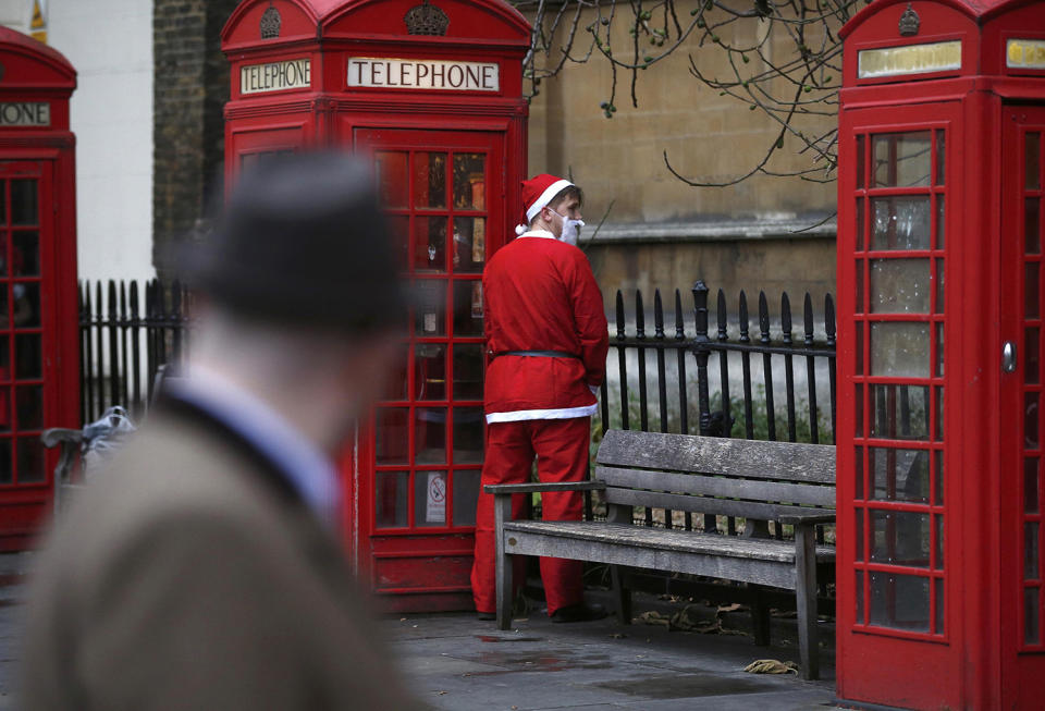 Santa Claus relieves himself during the Santacon