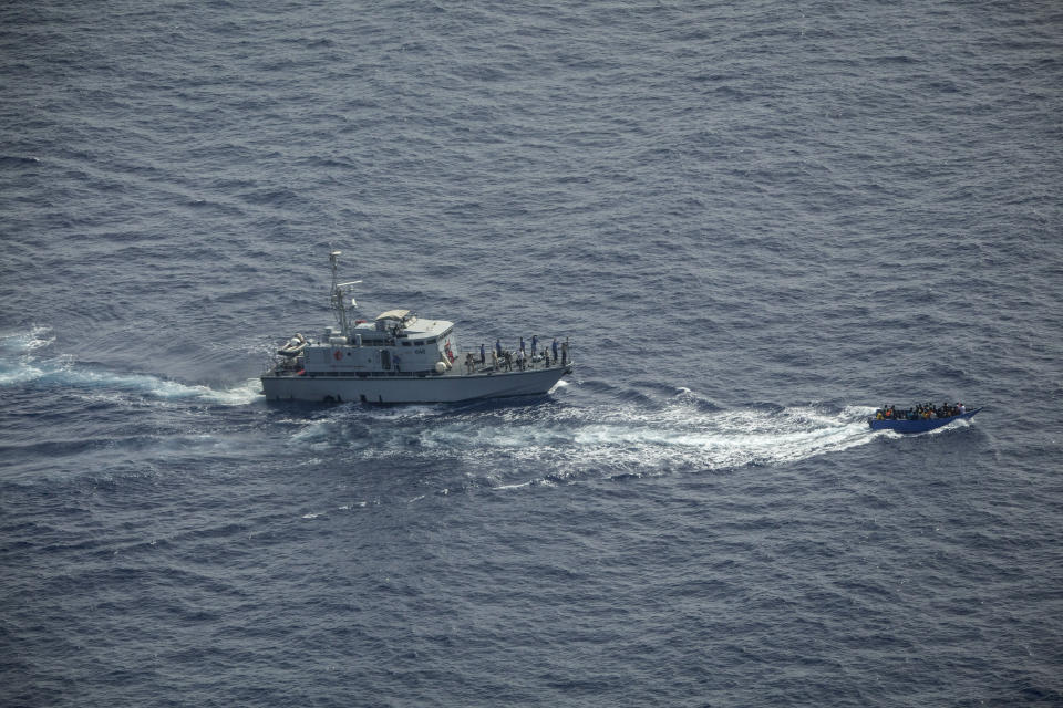 An overcrowded migrant boat, right, tries to escape from the Libyan Coast Guard in the Mediterranean Sea, Wednesday, June 30, 2021. A non-profit sea rescue group is denouncing the Libyan Coast Guard and the European Union after it witnessed and filmed the Libyan maritime authorities chasing a crowded migrant boat and shooting in its direction as it tried to stop it from crossing the Mediterranean Sea to Europe. The video was filmed Wednesday by members of Sea-Watch as they flew over the Central Mediterranean during an observation mission and caught the incident on camera from their plane. (Sea-Watch.org via AP)