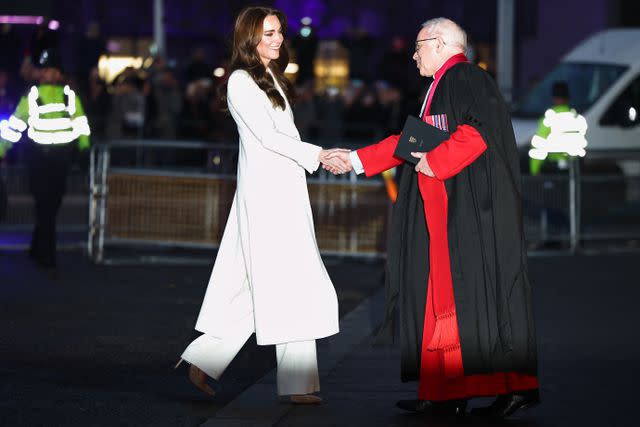 <p>HENRY NICHOLLS/AFP via Getty</p> Kate Middleton greets Dean of Westminster, David Hoyle as she arrives to attend the "Together At Christmas" concert at Westminster Abbey on Dec. 8.