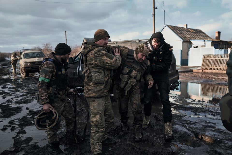 Ukrainian soldiers help a wounded comrade into an evacuation vehicle in the Donetsk region on Feb. 20, 2023.