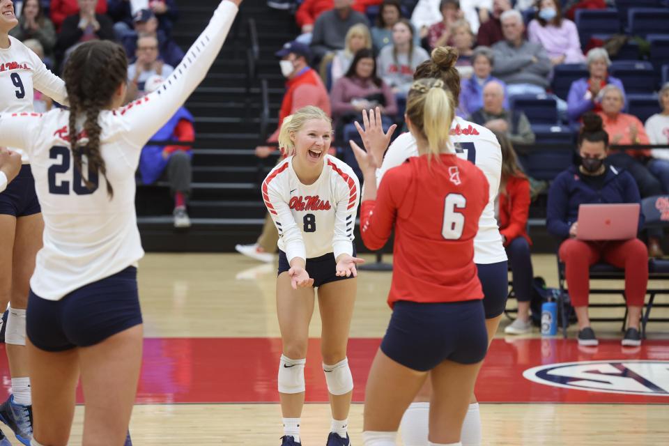 Ole Miss libero Maggie Miller (8) reacts with teammates Riley Fischer (6), Kylee McLaughlin (9) and Lauren Thompson (20) during a volleyball match against the Georgia Bulldogs on Thursday, Nov. 18, 2021, in Oxford, Mississippi.