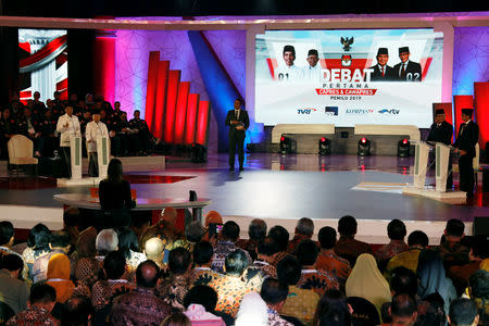 Indonesia's presidential candidate Joko Widodo (L) speaks beside his vice presidential candidate Ma'ruf Amin during a televised debate with his opponents Prabowo Subianto and his vice presidential candidate Sandiaga Uno in Jakarta, Indonesia January 17, 2019. REUTERS/Willy Kurniawan