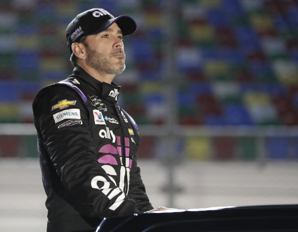 Jimmie Johnson rides down pit road after driver introductions before the first of two qualifying auto races for the NASCAR Daytona 500 at Daytona International Speedway, Thursday, Feb. 14, 2019, in Daytona Beach, Fla. (AP Photo/John Raoux)