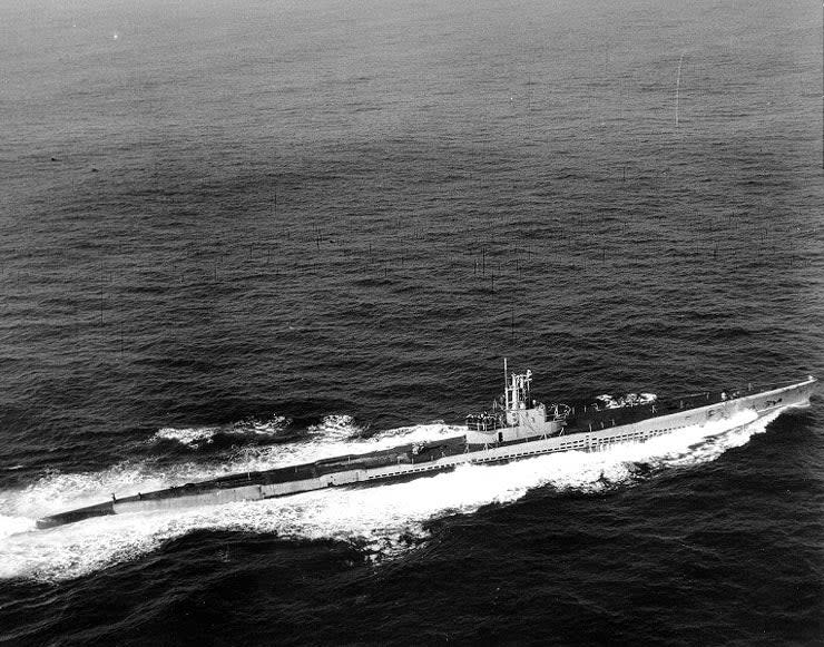 A blimp of Airship Patrol Squadron (ZP) 24 photographs <em>Salmon</em> as it steams through the deceptively calm Atlantic for Portsmouth Navy Yard, New Hampshire, February, 1945. <em>Naval History and Heritage Command</em>