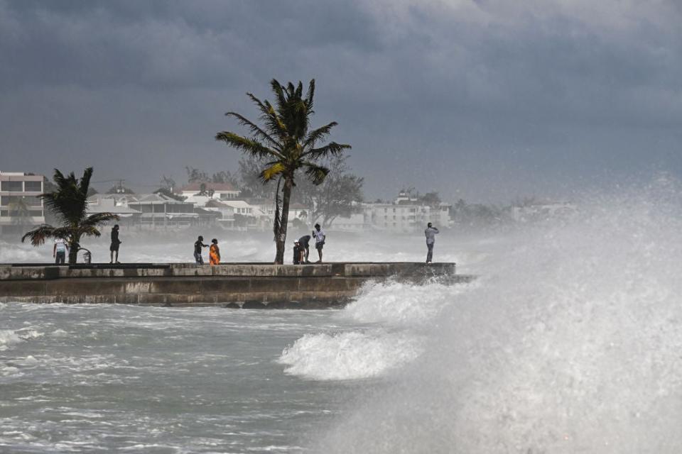 People visit a pier during a high tide after the passage of Hurricane Beryl in Oistins near Bridgetown, Barbados on July 1, 2024.