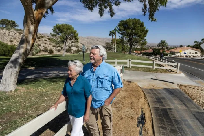 DESERT HOT SPRINGS, CA - SEPTEMBER 28, 2021: Ecologists couple Robin Kobaly and Doug Thompson are concerned about the amount of water used to irrigate golf courses in the Coachella Valley on September 28, 2021 in Desert Hot Springs, California. Standing near a fairway at Mission Lakes Country Club, Kobaly once volunteered to help the course change some grass areas to drought tolerant plants, but she's not sure if any changes were made. (Gina Ferazzi / Los Angeles Times)