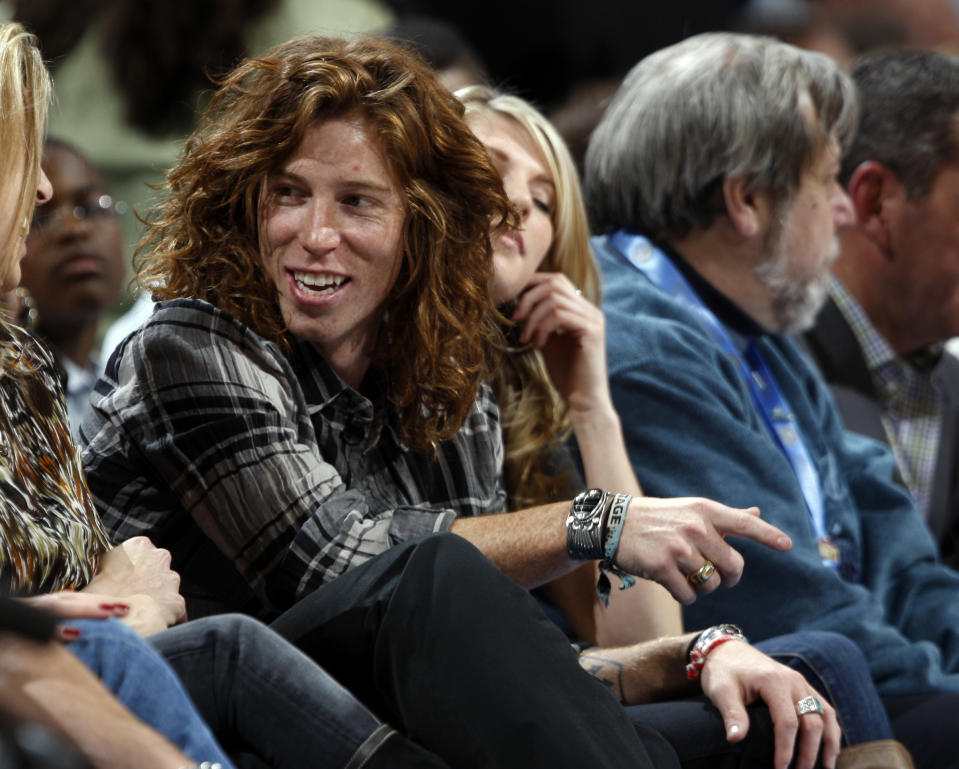 <p>Professional snowboader Shaun White, known as “The Flying Tomato,” sits in a courtside seat to watch the Golden State Warriors face the Denver Nuggets in the first quarter of an NBA basketball game in Denver on Tuesday, Dec. 1, 2009. (AP Photo/David Zalubowski) </p>