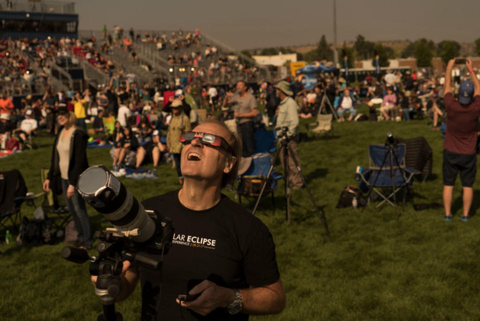 Steve Kaltenhauser of Calgary, Canada, watches with the crowd during a total solar eclipse from the Lowell Observatory Solar Eclipse Experience on Aug. 21, 2017 in Madras, Oregon. Emotional sky-gazers on the U.S. West Coast cheered and applauded Monday as the Sun briefly vanished behind the moon. / Credit: Stan Honda/AFP/Getty Images
