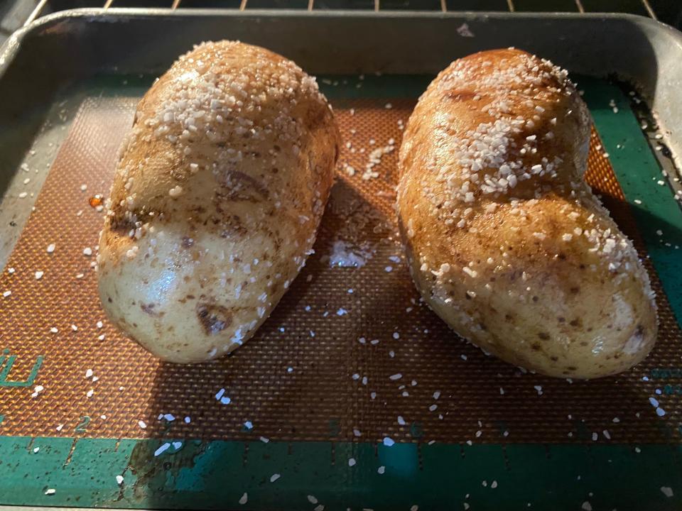 potatoes covered in salt baking in an oven