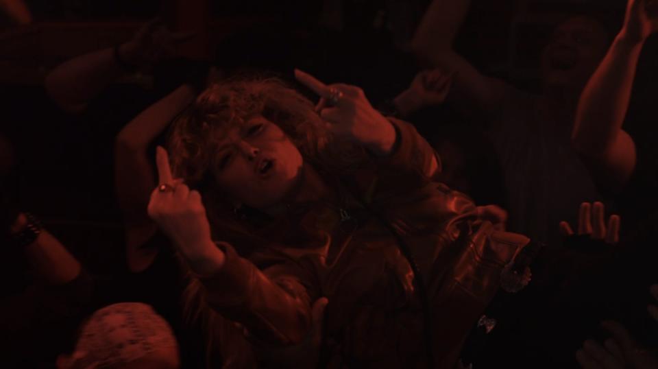 natasha lyonne crowd surfing and giving the middle finger in episode 4 of poker face