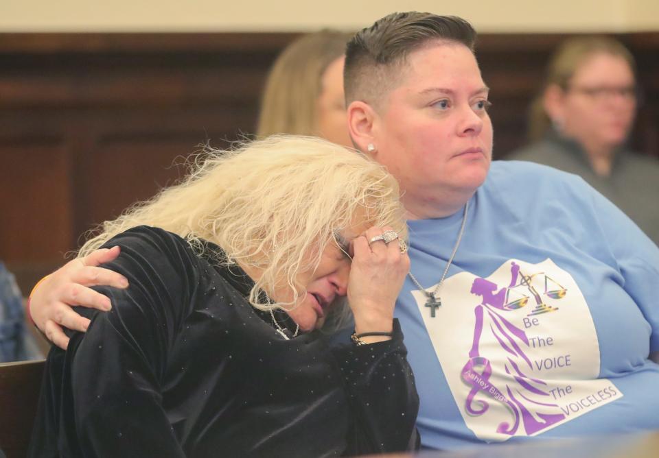 Kim Biggs, left, the mother of Ashley Biggs, is comforted by family friend Ashley Roa during victim impact statements on Thursday in Akron. Erica Stefanko was sentenced to life in prison with a possible parole after 30 years for her role in the 2012 murder of Ashley Biggs.