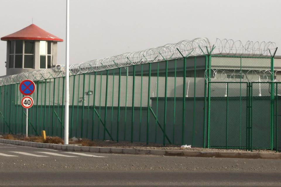 A guard tower and barbed wire fence surround a detention facility in the Kunshan Industrial Park in Artux in western China's Xinjiang region in 2018. A small core of international lawyers and activists are prodding leading Olympic sponsors to acknowledge China's widely reported human-rights abuses against Muslim Uyghurs, Tibetans and other minorities.