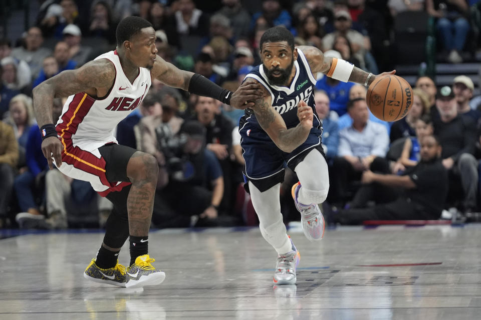 Dallas Mavericks guard Kyrie Irving (11) drives agains Miami Heat guard Terry Rozier (2) during the first half of an NBA basketball game in Dallas, Thursday, March 7, 2024. (AP Photo/LM Otero)