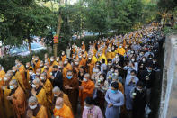 Monks and Thich Nhat Hanh followers trail behind the coffin of the Vietnamese Buddhist monk during his funeral in Hue, Vietnam Saturday, Jan. 29, 2022. A funeral was held Saturday for Thich Nhat Hanh, a week after the renowned Zen master died at the age of 95 in Hue in central Vietnam. (AP Photo/Thanh Vo)