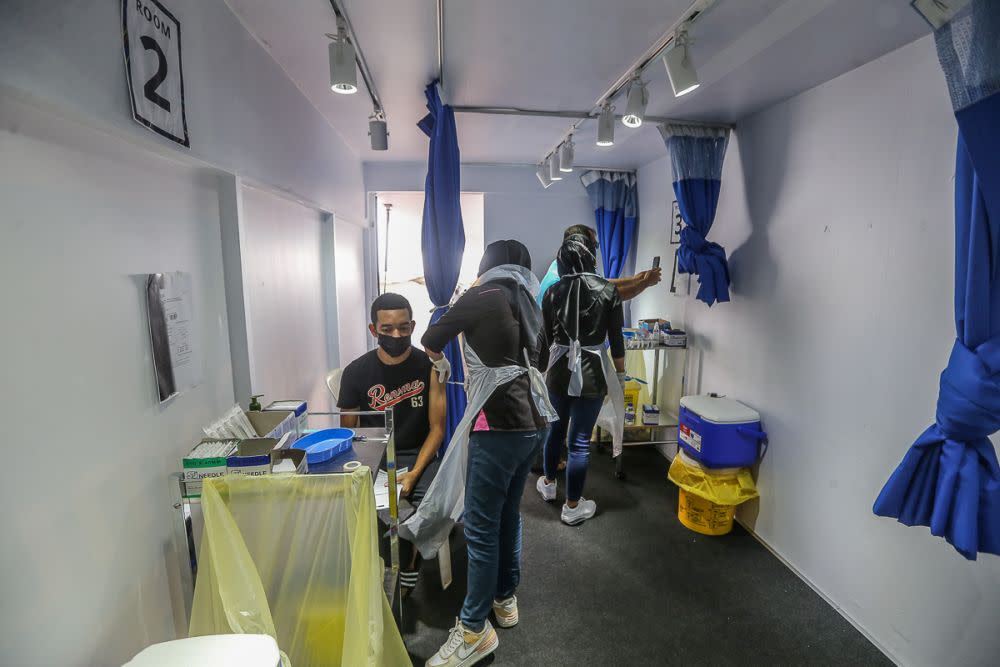 People receive their Covid-19 vaccination through the MYMedic@Wilayah Vaccine Mobile Truck programme at PPR Seri Alam in Kuala Lumpur June 23, 2021. — Picture by Yusof Mat Isa