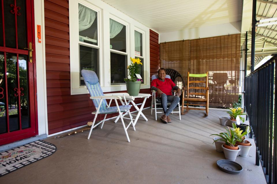 Alice Poindexter poses for a portrait on the front porch of her home in Columbus, Ohio June 17, 2021. Poindexter had her home siding completed through a grant from Nationwide Children's Hospital. "I felt like a queen," Poindexter said. "It felt like a new house." The house was Poindexter's family home in 1953, when her parents moved in it. She moved out in 1963 after high school. Her sister lived in the home, whom she received it from in 2003.