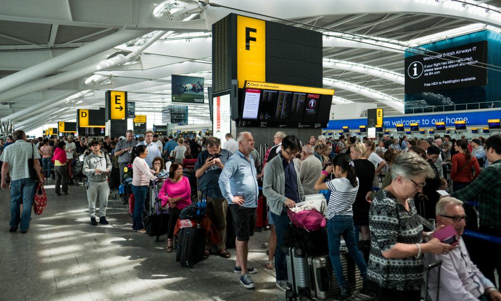 People queue for check-in at Heathrow Airport Terminal 5 on May 28, 2017 in London, England.