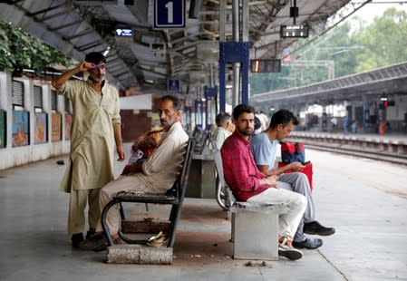 Danish Maqbool Malik waits to board a train at a railway station after meeting his brother Uzair Maqbool Malik in a central jail, in Agra