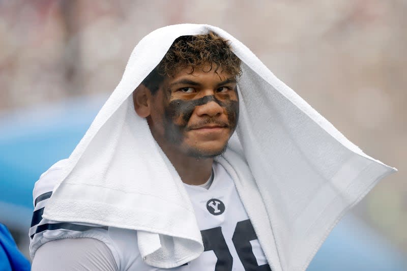 BYU offensive lineman Kingsley Suamataia cools off on the sideline during game against Kansas on Saturday, Sept. 23, 2023 in Lawrence, Kan.