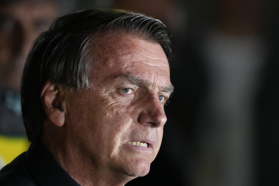 Brazilian President Jair Bolsonaro, who is running for another term, gestures during a press conference after general election polls closed in in Brasilia, Brazil, Sunday, Oct. 2, 2022. (AP Photo/Eraldo Peres)