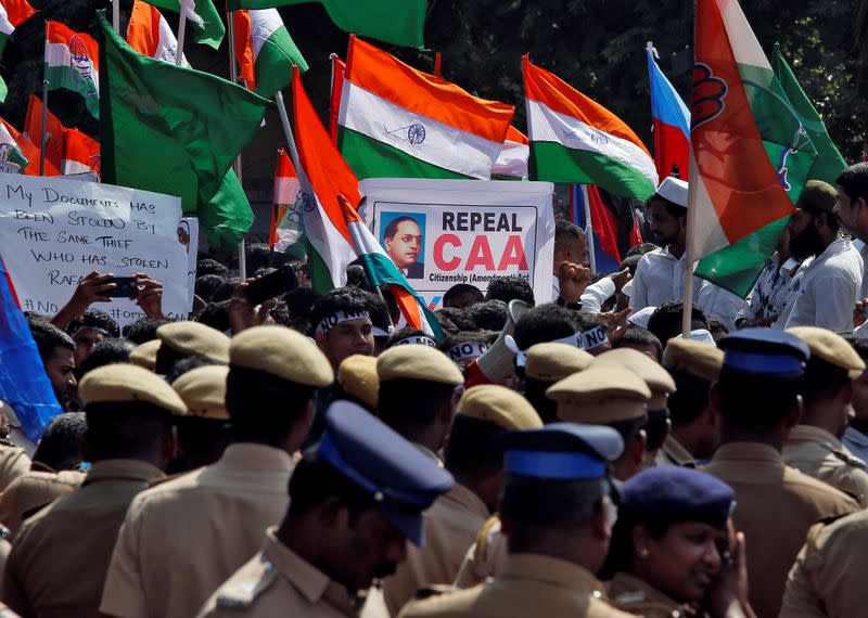 Police officers stand as demonstrators gather to attend a protest against a new citizenship law, in Chennai