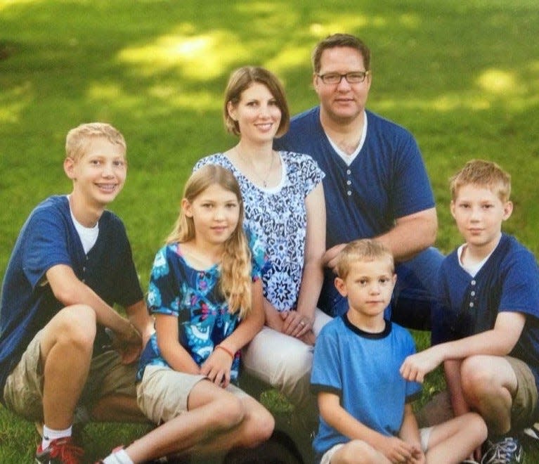 Molly/Ollie with parents, Erin and Allen, and three brothers.