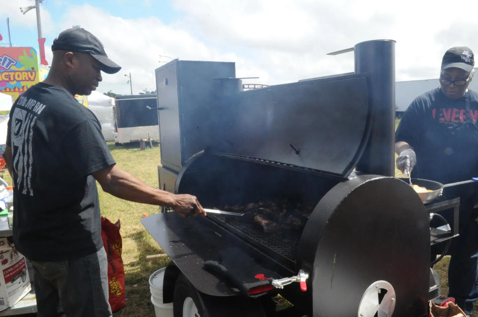 Garey Lee cooks Jerk Chicken and Thelma Jackson both of Flavor Jamaica of Brockton cooks platoons at the Brockton Fair on Saturday, July1, 2017.