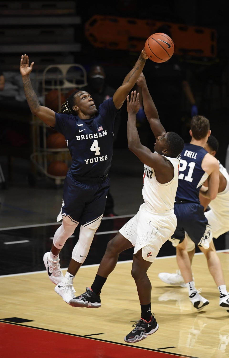 BYU guard Brandon Averette (4) blocks a shot by San Diego State guard Terrell Gomez (3) during the second half of an NCAA college basketball game Friday, Dec. 18, 2020, in San Diego. (AP Photo/Denis Poroy)