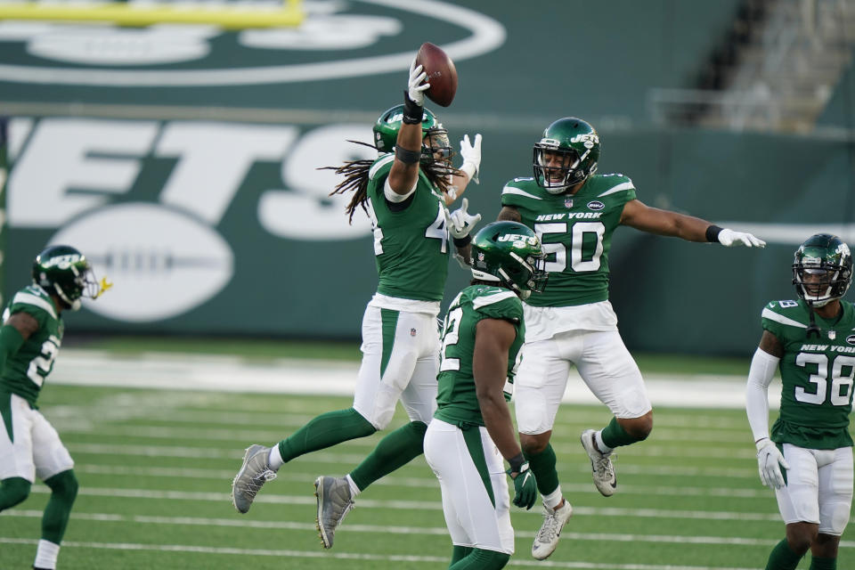 New York Jets' Harvey Langi, top, center, celebrates his fumble recovery during the second half of an NFL football game against the Miami Dolphins, Sunday, Nov. 29, 2020, in East Rutherford, N.J. (AP Photo/Corey Sipkin)