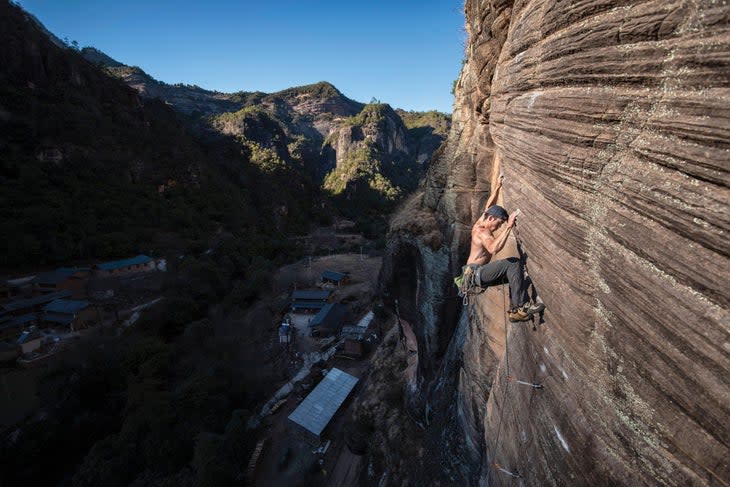 <span class="article__caption">Ryder Stroud comes to grips with <em>Velocio-opteryx</em> (5.12). FA: Mike Dobie, who else? Stroud was sponsored by various climbing companies to explore and develop the remote mountainous regions of western China. In under three months he journeyed through Yunnan, Sichuan, Qinghai, and Xinjiang provinces. The result: his guidebook Wild West China Exploration (2015), available online. <em>Velocio-opteryx</em> is on the Wifi Wall, one of five crags in the The Sport Climbers Area. Most of the crags are just a five-minutes stroll from the road. At the Wifi, you can, in fact, belay from your car--and pick up wifi!</span>