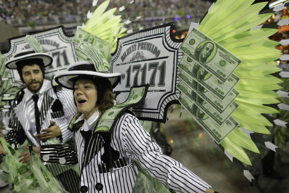 Performers from the Sao Clemente samba school parade during Carnival celebrations at the Sambadrome in Rio de Janeiro, Brazil, Monday, Feb. 24, 2020. (AP Photo/Silvia Izquierdo)