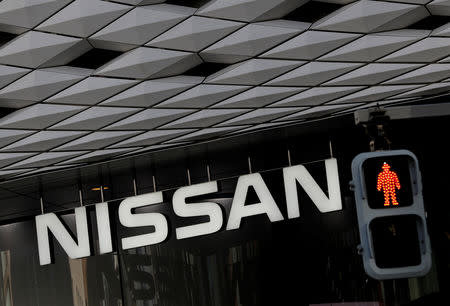 Nissan's signboard is seen behind a traffic sign at its showroom in Tokyo, Japan, December 14, 2018. REUTERS/Kim Kyung-Hoon