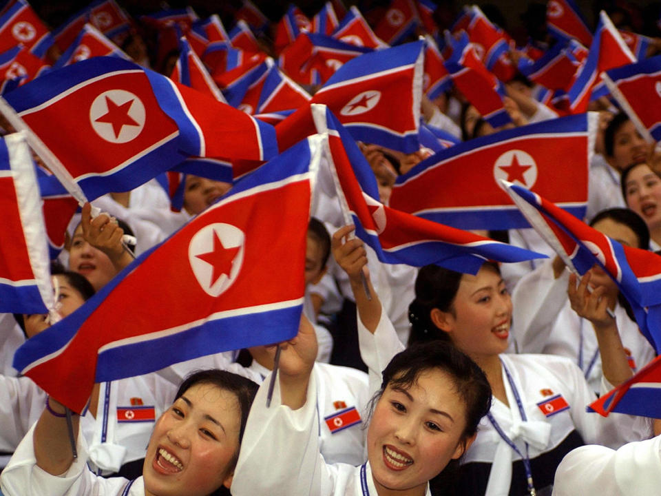 North Korean cheerleaders wave their national flags during the World Student Games in Daegu, South Korea, in 2003: Getty Images