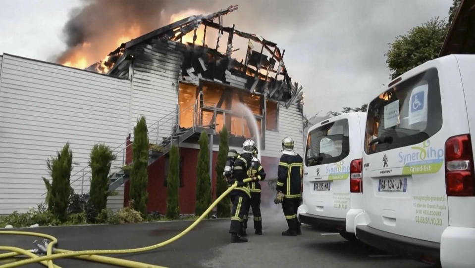 Firefighters try to contain the blaze at a vacation home in the town of Wintzenheim, north-eastern France, Wednesday Aug. 9, 2023. A fire ripped through a vacation home for adults with disabilities in eastern France on Wednesday, killing several people, the head of rescue operations said. (TNN/dpa via AP)