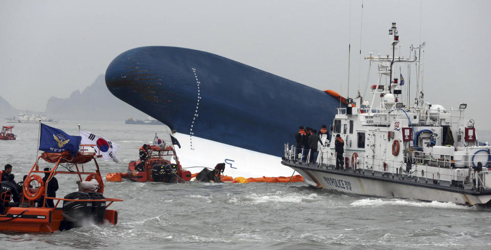 South Korean Coast Guard officers try to rescue missing passengers from a sunken ferry in the water off the southern coast near Jindo, south of Seoul, South Korea, Thursday, April 17, 2014. Fears rose Thursday for the fate of more than 280 passengers still missing more than 24 hours after their ferry flipped onto its side and filled with water off the southern coast of South Korea. (AP Photo/Yonhap) KOREA OUT