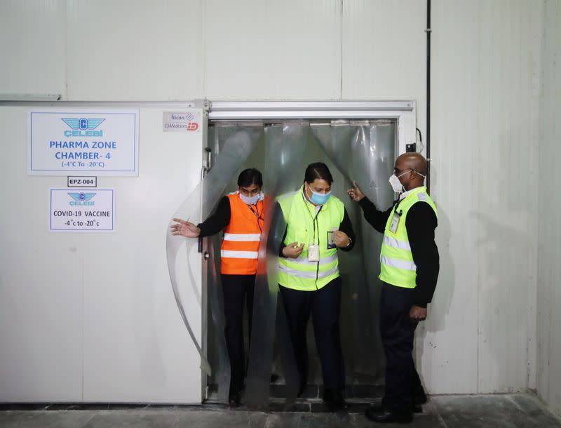 Ground staff exit a temperature-controlled storage room at a cargo terminal of the Indira Gandhi International Airport