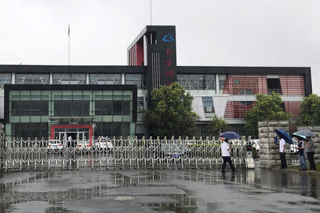 FILE PHOTO: People gather at the gate of Changchun Changsheng Bio-technology Co Ltd, the Chinese vaccine maker, in Changchun, China July 26, 2018. REUTERS/Philip Wen